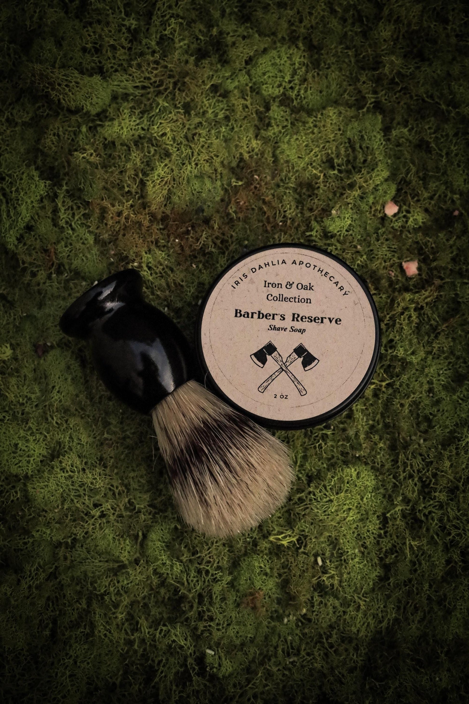 a shaving brush and shave soap sitting on top of a lush green field