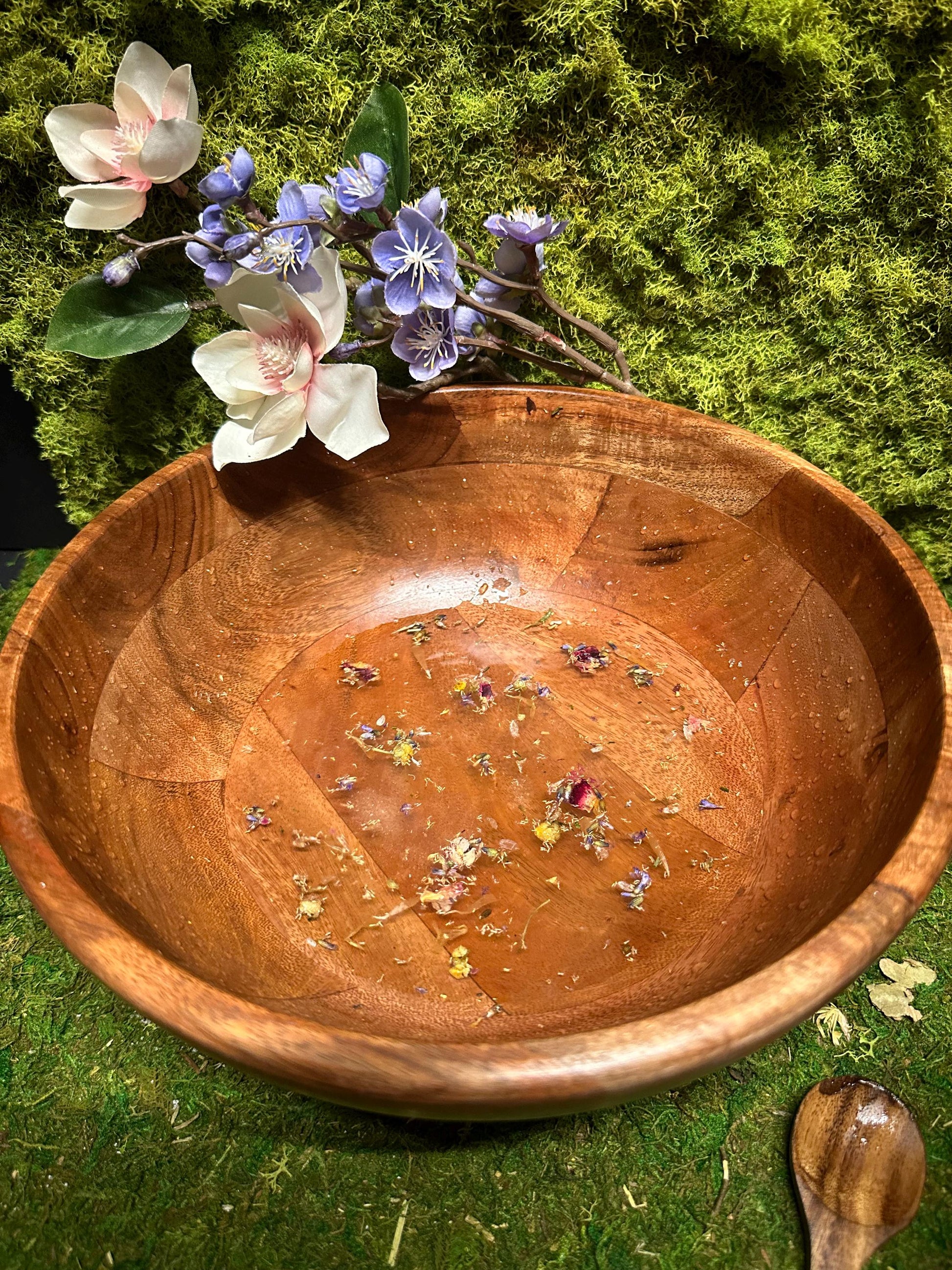 Floral Garden Bath Salts floating in water in wooden bowl