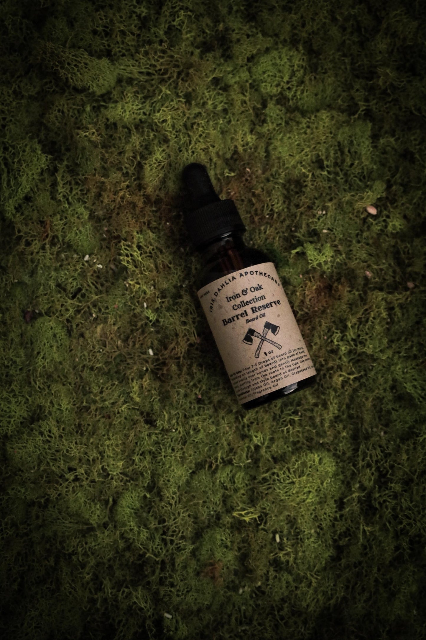 a bottle of shave oil sitting on moss